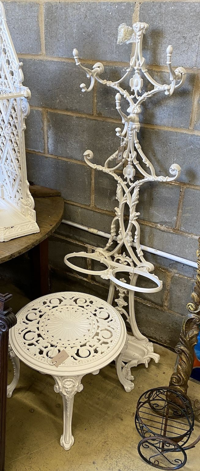 A Victorian cast iron hall stand, height 154cm, reduced and a later circular cast metal table (both later painted)